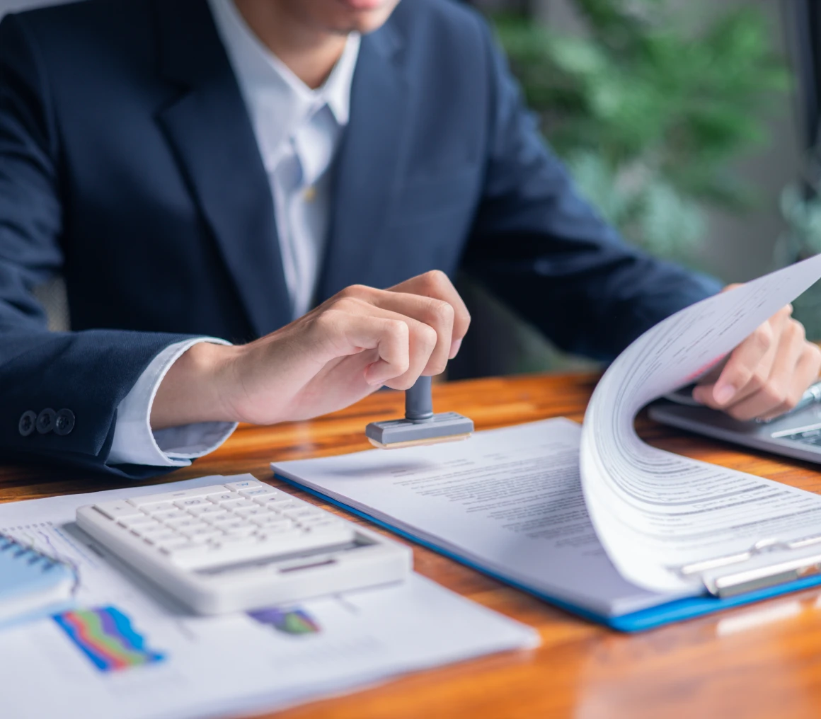 Businessman using stamp on paperwork