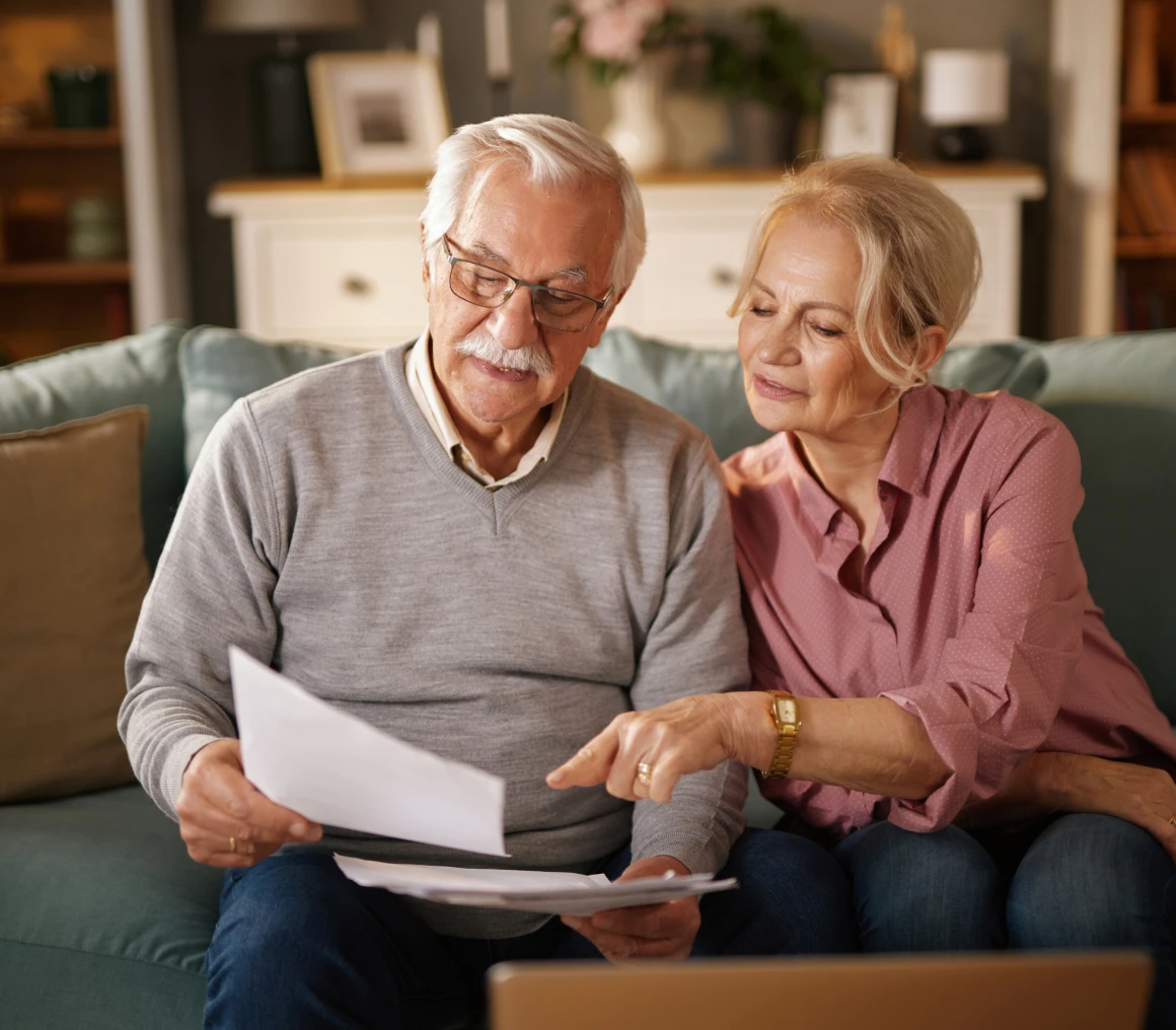 Older couple checking financial papers