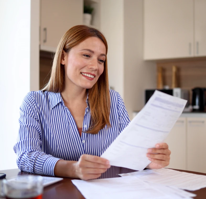 Woman reading a document at home